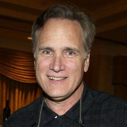 A man in a black shirt smiling for the camera at a Dallas restaurant.